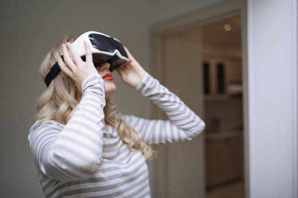 istock Woman wearing Virtual reality headset 1354260649