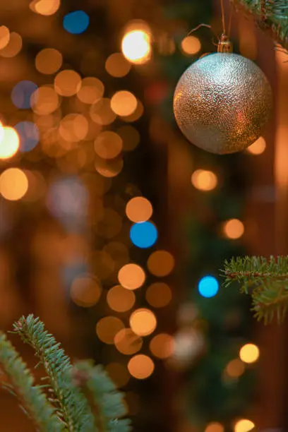 Photo of glowing lamps atmosphere street December holidays festive space with background illumination bokeh light from garland lamps and ball toy foreground focus objects
