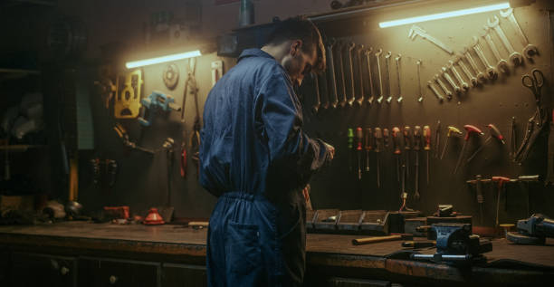 istock Young blacksmith man working standing at the workbench at his own workshop 1354261407