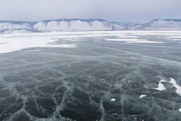 istock Baikal lake in winter, ice formations, cliff, snow landscape 1354262113