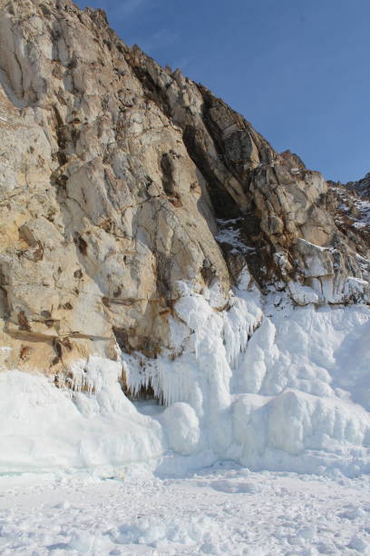istock Baikal lake in winter, ice formations, cliff, snow landscape 1354262176