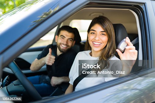 istock Latin couple taking their new car for a ride 1354262266