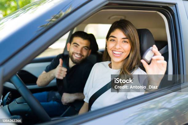 Latin Couple Taking Their New Car For A Ride Stock Photo - Download Image Now - Car, New, Shopping