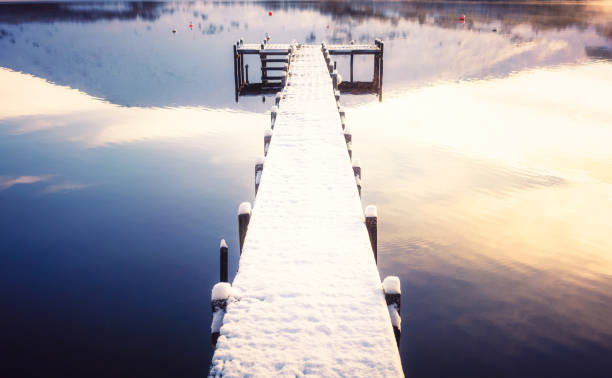 istock Beautiful snow covered jetty at dawn 1354267894