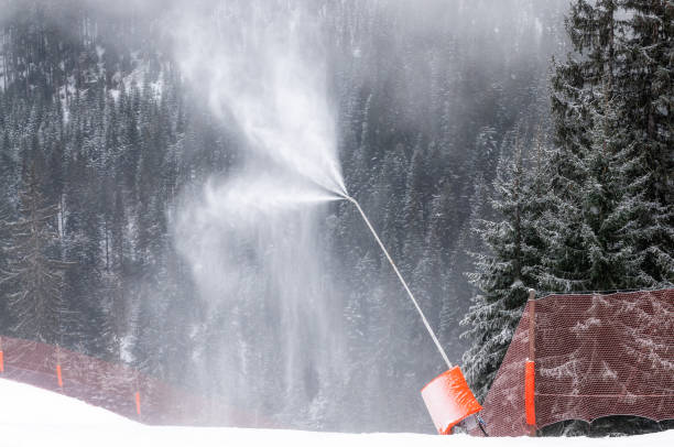 artificial snow production at ski resort - fake snow imagens e fotografias de stock