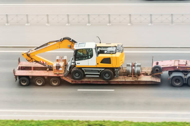 a large truck featuring an excavator on its rear