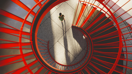 Overhead view from the top of a red staircase in a modern office building. All objects in the scene are 3D