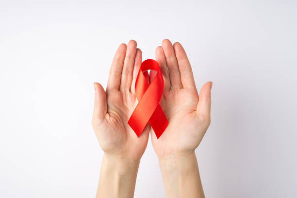 고립 된 흰색 배경에 대한 인식을 돕는 손바닥에 빨간 실크 리본을 들고있는 젊은 여성의 손1 인칭 상단 보기 사진 - aids awareness ribbon 뉴스 사진 이미지