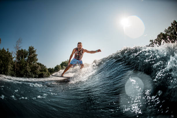 istock beautiful view of splashing wave and man riding it on foilboard 1354270876