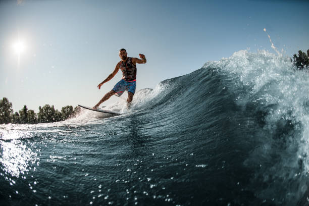 istock view of great splashing wave and man riding it on foilboard 1354271223