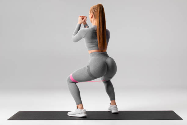 Athletic girl doing squats exercise for glutes ripl fitness