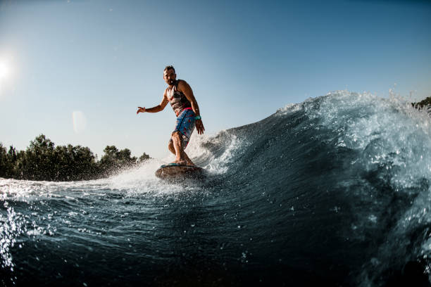 istock man ride down on splashing river wave on foilboard at summer day 1354271893