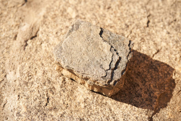 istock Stone podium on a beige background for a natural design concept. Central composition, top view 1354272587