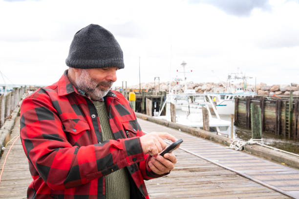 istock A commercial fisherman on wharf using a mobile phone 1354274828