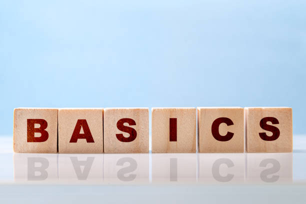 istock Basics word written on wood blocks on blue background. Back to basics or simplifying business concept. 1354275998