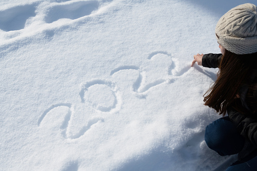 View of New Year 2022 Drawn by Teenager on a Snowy Surface on the Ground