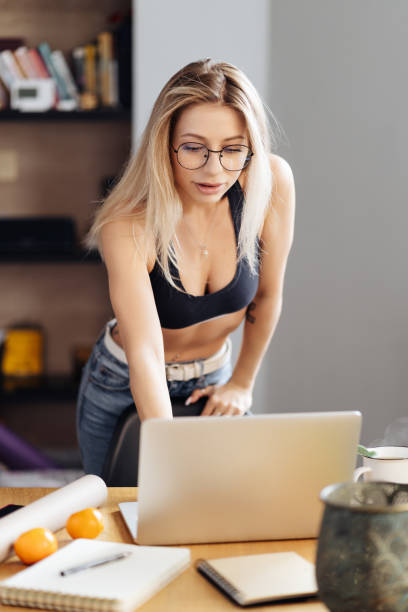 istock Young woman wearing glasses sit at desk watch webinar making notes 1354276317