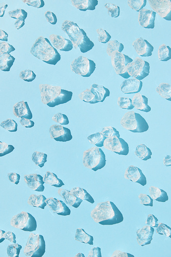 Close up crushed ice in sunlight. Summer pattern background refreshment concept. Flat lay top view