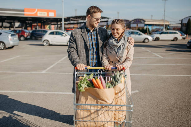 istock Happy couple riding shopping trolley 1354278289