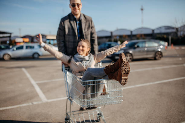 istock Happy couple riding shopping trolley 1354278291