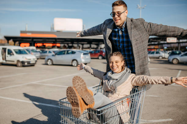 istock Happy couple riding shopping trolley 1354278293