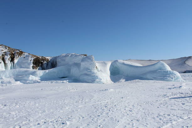 istock Baikal lake in winter, ice formations, cliff, snow landscape 1354278343
