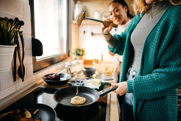 istock Couple making pancakes at home. 1354280092
