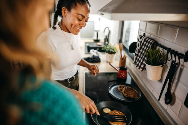 istock Couple making pancakes at home. 1354280110