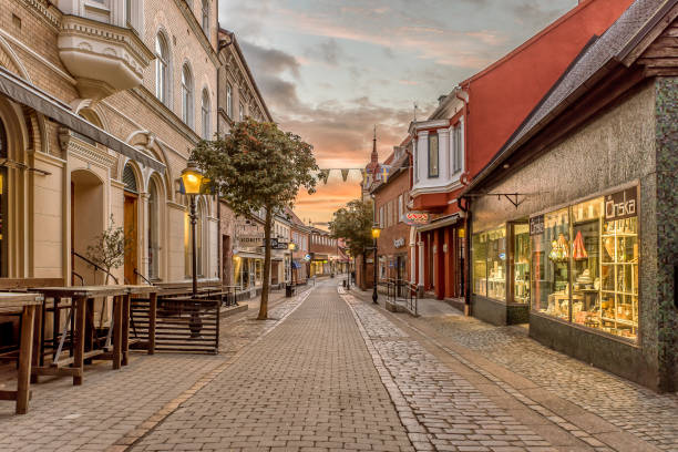 the shopping street in Ystad an early morning at sunrise with illuminated storefronts stock photo