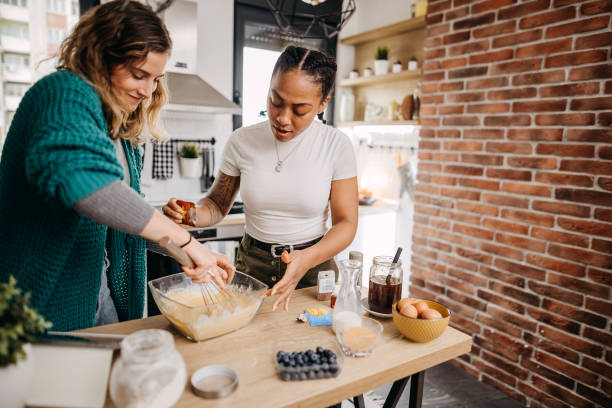 istock Couple making pancakes at home. 1354281356