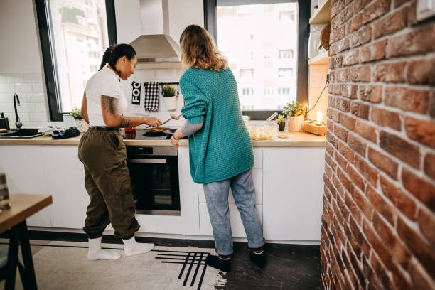 istock Couple making pancakes at home. 1354281530