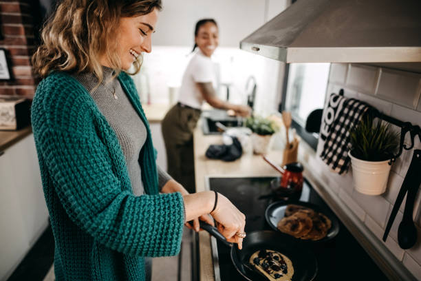 istock Couple making pancakes at home. 1354281567