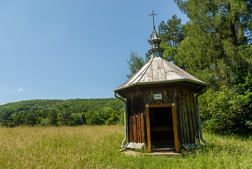 A chapel surrounded by fields and forests on a sunny summer day, Kalwaria Pacawska, Poland