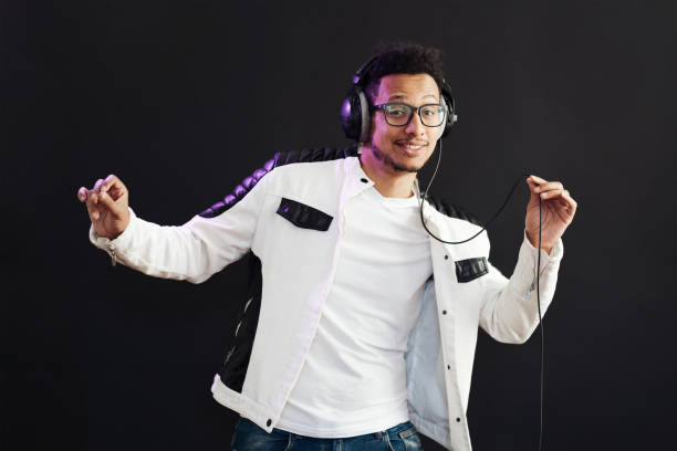 istock Carefree dark skinned guy listens lively music 1354283165