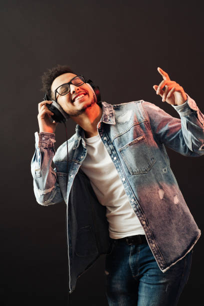 istock Carefree dark skinned guy listens lively music 1354284074