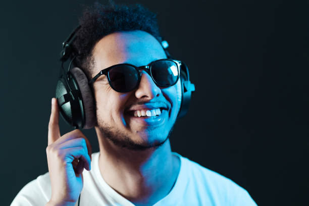 istock Carefree dark skinned guy listens lively music 1354284170