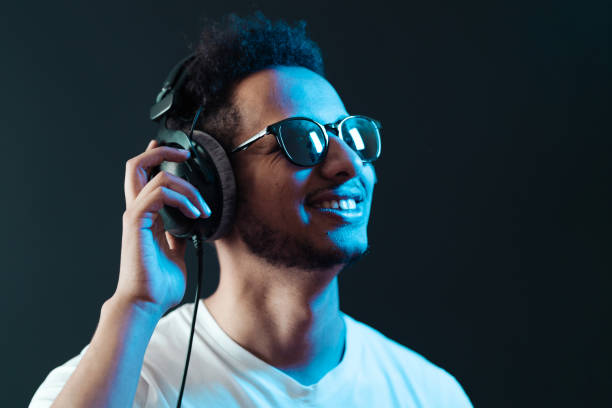 istock Carefree dark skinned guy listens lively music 1354284198