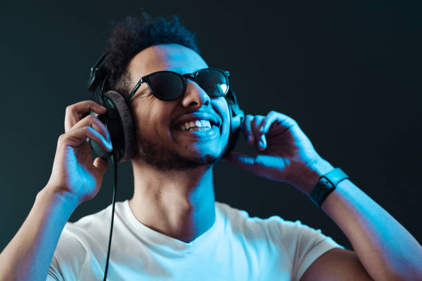 istock Carefree dark skinned guy listens lively music 1354284207