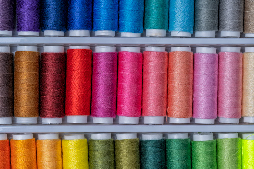 A Collection of sewing thread spools with threads of all colors