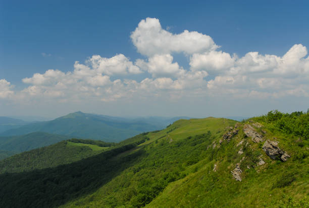 Green mountain hills against a blue sky on a sunny summer day, Bieszczady Mountains, Poland