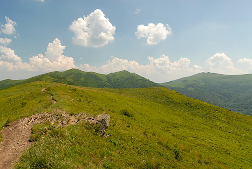 Green mountain hills against a blue sky on a sunny summer day, Bieszczady Mountains, Poland