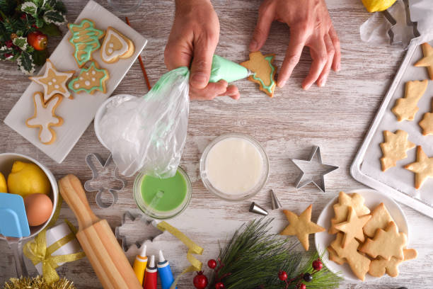 Decorating Christmas themed cookies with colored icing top