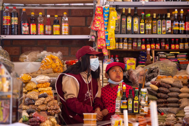 Urubamba, Cusco - Peru - October 10th 2021: Image of seller in small market in Urubamba, Cusco, Peru.\nWoman seller of food products and ingredients.