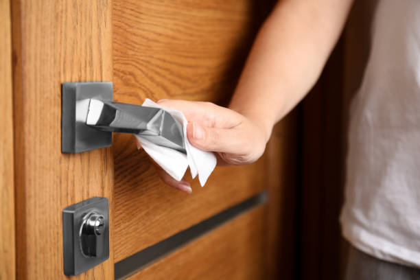 istock Woman using tissue paper to open door, closeup 1354303269