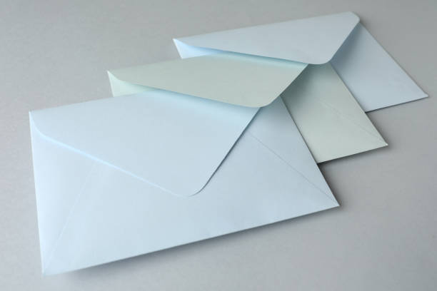 istock White paper envelopes on light grey background, closeup. Mail service 1354304435