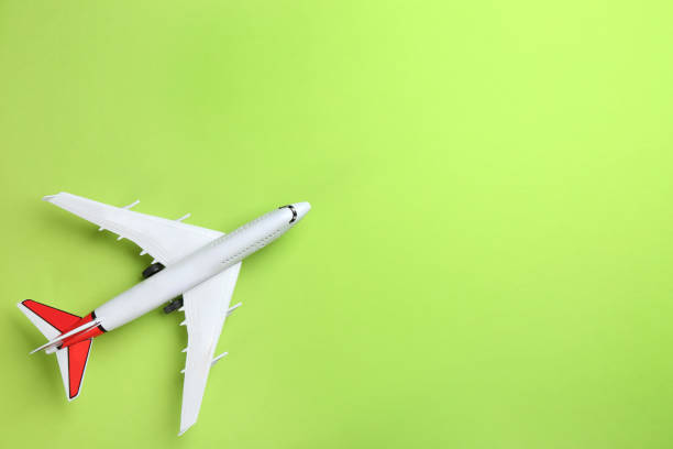 istock Toy airplane on green background, top view. Space for text 1354304438