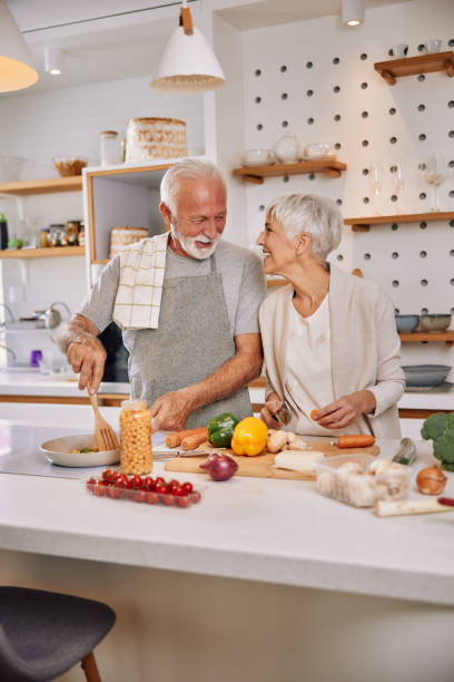 istock An elderly couple having fun in the kitchen preparing healthy food 1354304579