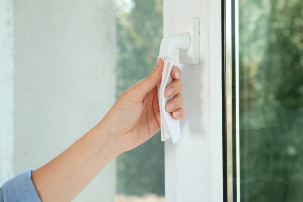 istock Woman using tissue paper to open window indoors, closeup 1354306114