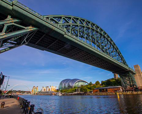 Newcastle upon Tyne, UK - August 24th 2021: The Tyne Bridge with the Sage Gateshead and Gateshead Millennium Bridge, in the city of Newcastle upon Tyne in Northumberland, UK.