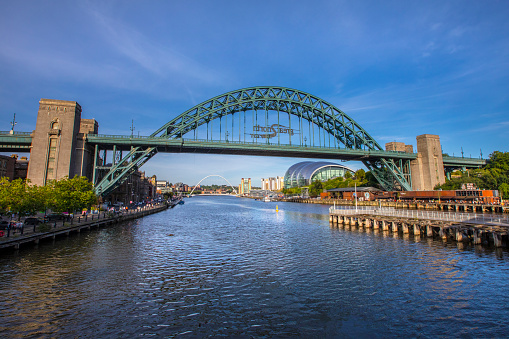 Newcastle upon Tyne, UK - August 24th 2021: The Tyne Bridge with the Sage Gateshead and Gateshead Millennium Bridge, in the city of Newcastle upon Tyne in Northumberland, UK.